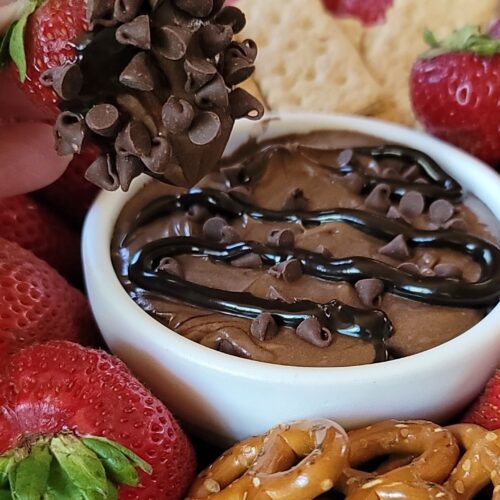 Chocolate dip with strawberries and graham crackers.